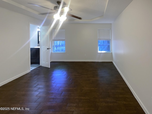 624 Staffordshire Dr, Jacksonville, FL 32225 - empty room featuring ceiling fan, dark wood-style floors, baseboards, and a tray ceiling