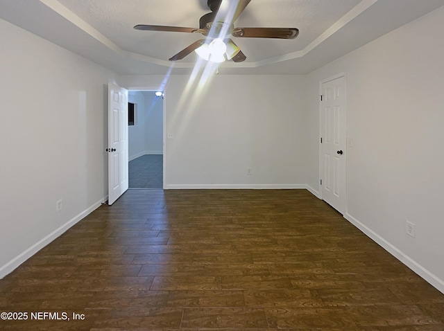 624 Staffordshire Dr, Jacksonville, FL 32225 - unfurnished room with a raised ceiling, dark wood finished floors, ceiling fan, and baseboards
