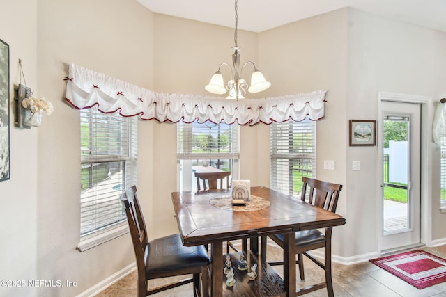 104 Twin Lakes Dr, Saint Augustine, FL 32084 - tiled dining area featuring a chandelier, baseboards, and a towering ceiling