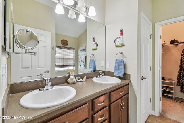 104 Twin Lakes Dr, Saint Augustine, FL 32084 - full bath with double vanity, a walk in closet, tile patterned flooring, and lofted ceiling
