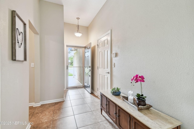104 Twin Lakes Dr, Saint Augustine, FL 32084 - entrance foyer with light tile patterned floors, a towering ceiling, and baseboards