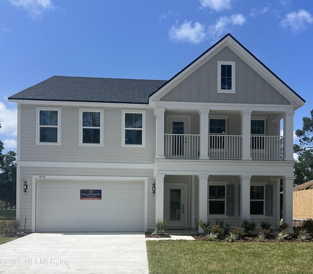 96124 Pirates Bluff Rd, Yulee, FL 32097 - view of front of home featuring board and batten siding, covered porch, a balcony, driveway, and a garage