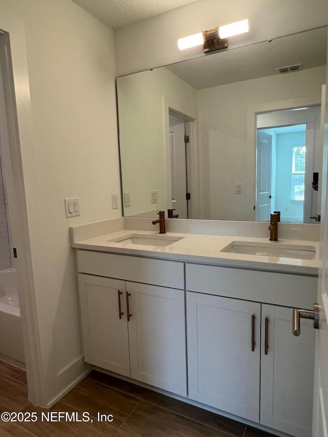 96124 Pirates Bluff Rd, Yulee, FL 32097 - bathroom with double vanity, wood finished floors, and a tub to relax in