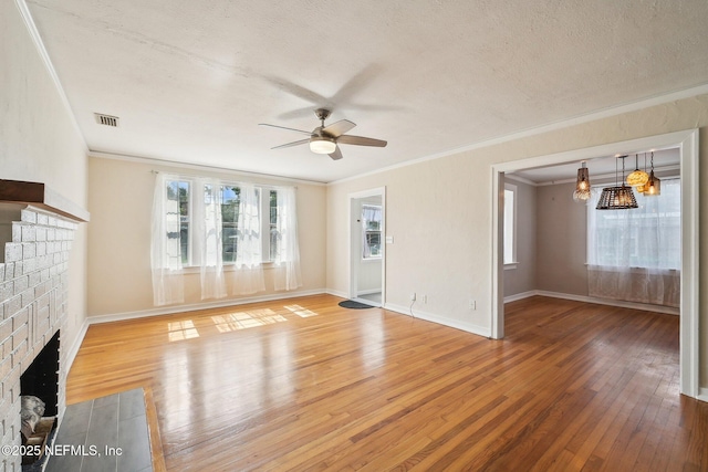4253 Redwood Ave, Jacksonville, FL 32207 - unfurnished living room with a brick fireplace, ornamental molding, a ceiling fan, light wood-style floors, and a textured ceiling