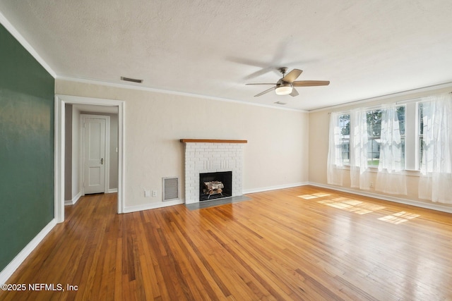 4253 Redwood Ave, Jacksonville, FL 32207 - unfurnished living room featuring a ceiling fan, light wood-style flooring, ornamental molding, a fireplace, and baseboards