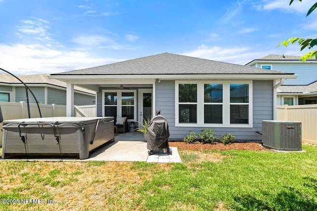 9789 Intellect Trl, Jacksonville, FL 32256 - rear view of property with central AC unit, a patio, a hot tub, ceiling fan, and roof with shingles