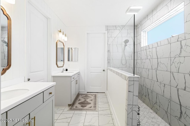 9789 Intellect Trl, Jacksonville, FL 32256 - bathroom featuring marble look tile flooring, a walk in shower, and two vanities