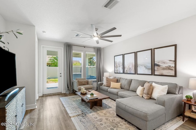 9789 Intellect Trl, Jacksonville, FL 32256 - living room with light wood-style flooring, ceiling fan, and baseboards