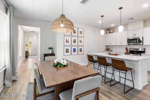 9789 Intellect Trl, Jacksonville, FL 32256 - dining space featuring light wood-type flooring, recessed lighting, and baseboards