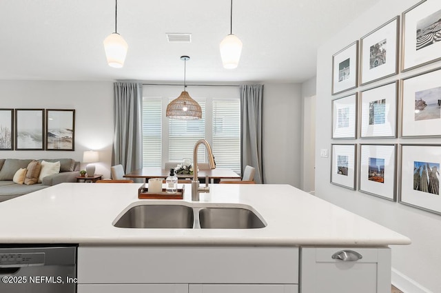 9789 Intellect Trl, Jacksonville, FL 32256 - kitchen featuring dishwashing machine, a sink, light countertops, open floor plan, and decorative light fixtures
