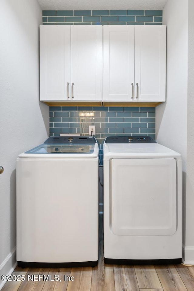 9789 Intellect Trl, Jacksonville, FL 32256 - washroom featuring cabinet space, independent washer and dryer, light wood finished floors, and baseboards