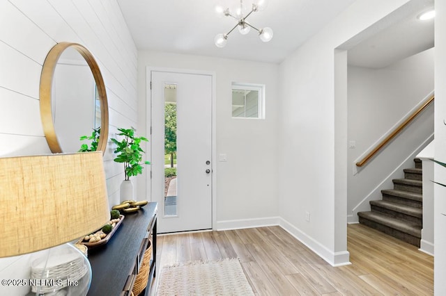 9789 Intellect Trl, Jacksonville, FL 32256 - foyer entrance with light wood-type flooring, stairs, a chandelier, and baseboards