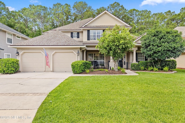 1159 Eastwood Branch Dr, Saint Johns, FL 32259 - view of front facade with a garage, stucco siding, a front lawn, driveway, and a shingled roof