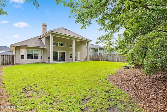 1159 Eastwood Branch Dr, Saint Johns, FL 32259 - rear view of house featuring a chimney, stucco siding, and roof with shingles