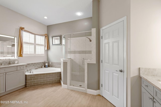 1159 Eastwood Branch Dr, Saint Johns, FL 32259 - bathroom with vanity, a bath, a stall shower, and wood finished floors