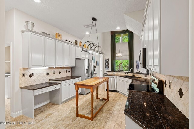 1159 Eastwood Branch Dr, Saint Johns, FL 32259 - kitchen featuring stainless steel appliances, a sink, backsplash, white cabinets, and recessed lighting
