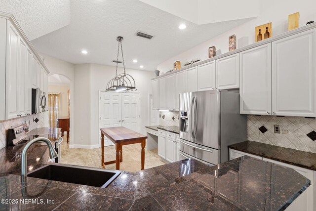 1159 Eastwood Branch Dr, Saint Johns, FL 32259 - kitchen with appliances with stainless steel finishes, arched walkways, a sink, tasteful backsplash, and recessed lighting