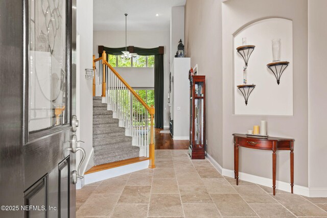 1159 Eastwood Branch Dr, Saint Johns, FL 32259 - entryway with baseboards, stairway, and stone tile floors