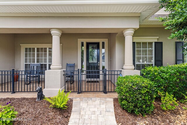 1159 Eastwood Branch Dr, Saint Johns, FL 32259 - property entrance with stucco siding and a porch