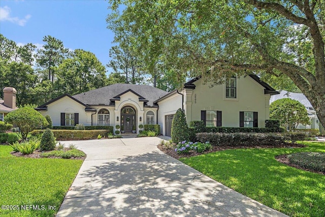 3995 Cattail Pond Dr, Jacksonville, FL 32224 - french country inspired facade featuring driveway, stucco siding, a garage, and a front yard