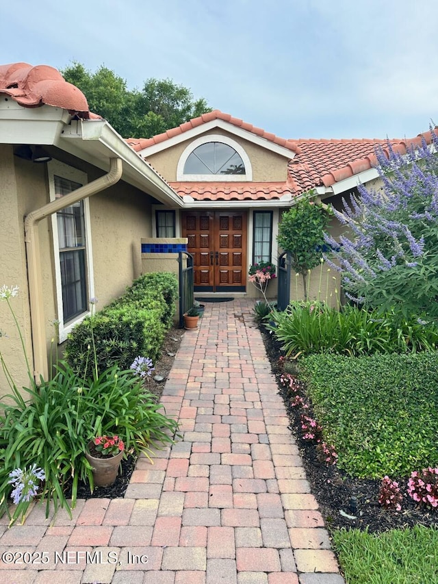 4026 Corrientes Ct E, Jacksonville, FL 32217 - entrance to property with stucco siding and a tiled roof
