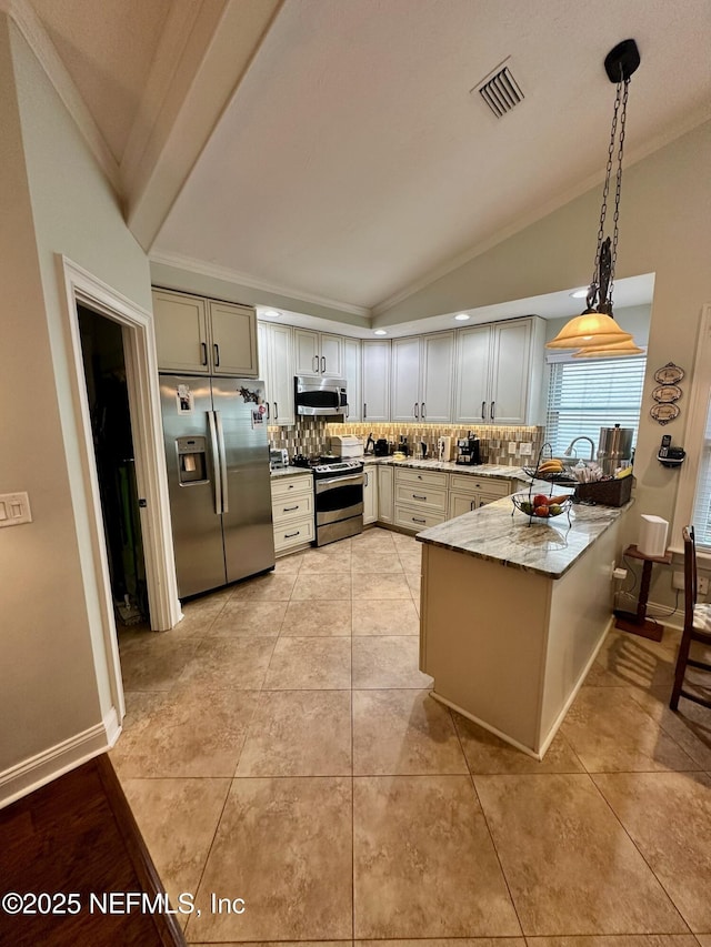 4026 Corrientes Ct E, Jacksonville, FL 32217 - kitchen featuring stainless steel appliances, lofted ceiling, a peninsula, backsplash, and crown molding