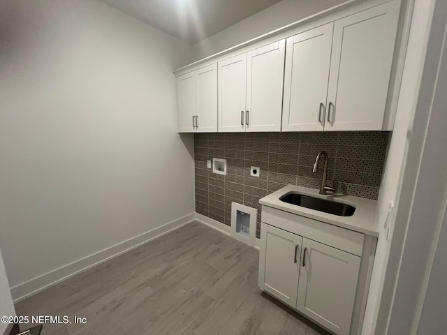 96088 Pirates Bluff Rd, Yulee, FL 32097 - laundry room featuring hookup for an electric dryer, cabinet space, hookup for a washing machine, and light wood finished floors