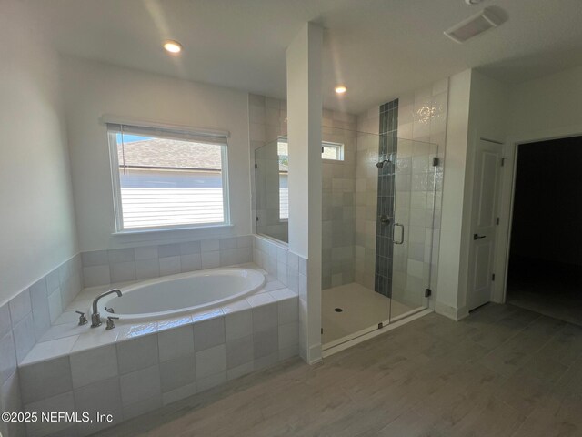 96088 Pirates Bluff Rd, Yulee, FL 32097 - bathroom with a bath, a shower stall, and wood finished floors
