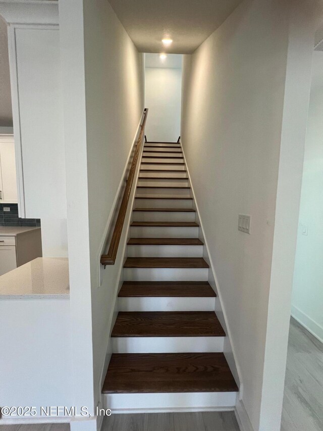 96088 Pirates Bluff Rd, Yulee, FL 32097 - stairs with baseboards and wood finished floors
