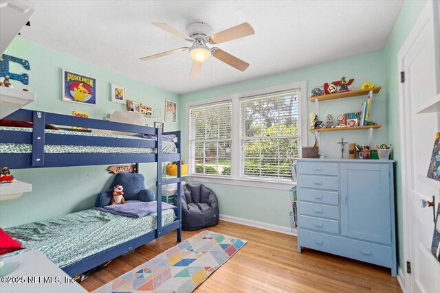 4651 Pinewood Ave, Jacksonville, FL 32207 - bedroom with wood finished floors, baseboards, and ceiling fan