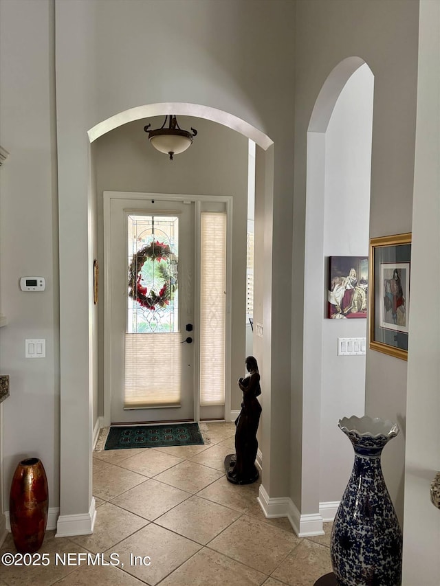 501 N Legacy Trl, Saint Augustine, FL 32092 - foyer featuring arched walkways, light tile patterned flooring, and baseboards