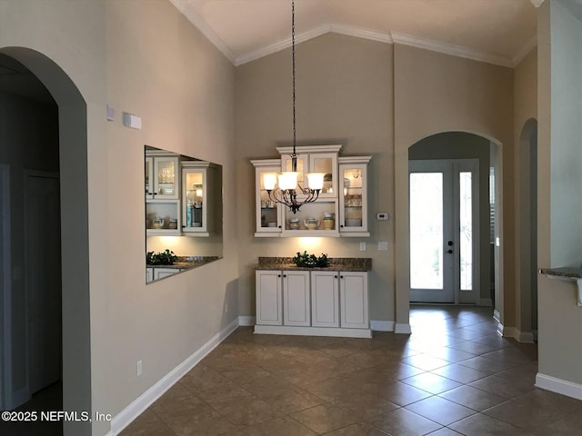 501 N Legacy Trl, Saint Augustine, FL 32092 - bar featuring baseboards, high vaulted ceiling, arched walkways, ornamental molding, and pendant lighting