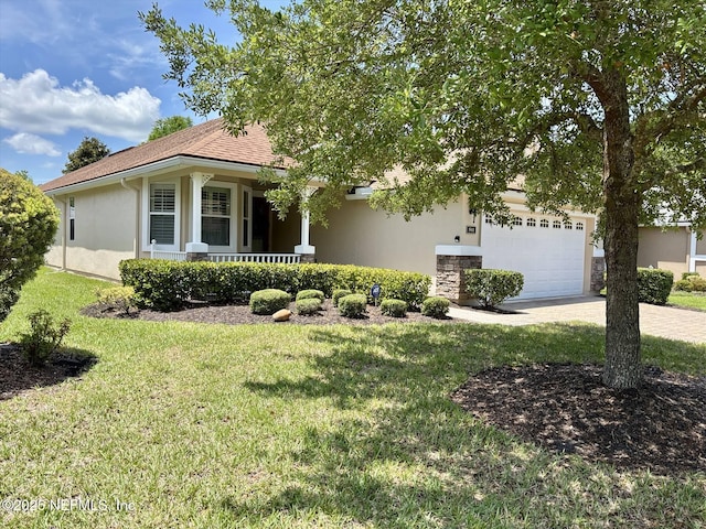 501 N Legacy Trl, Saint Augustine, FL 32092 - view of front of house with stucco siding, a front yard, driveway, a porch, and an attached garage