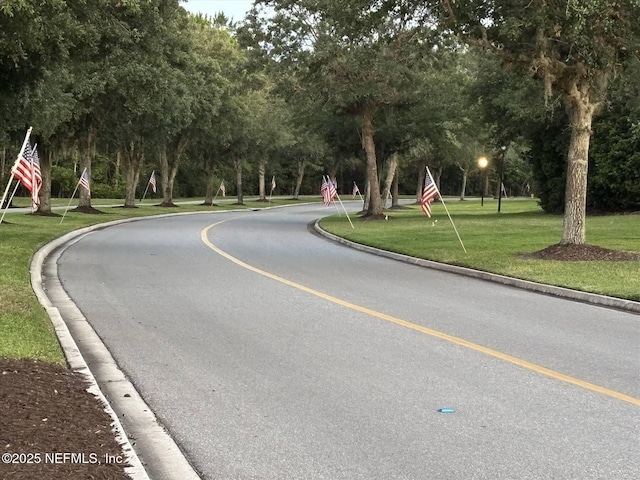 501 N Legacy Trl, Saint Augustine, FL 32092 - view of asphalt street with curbs and view of wooded area