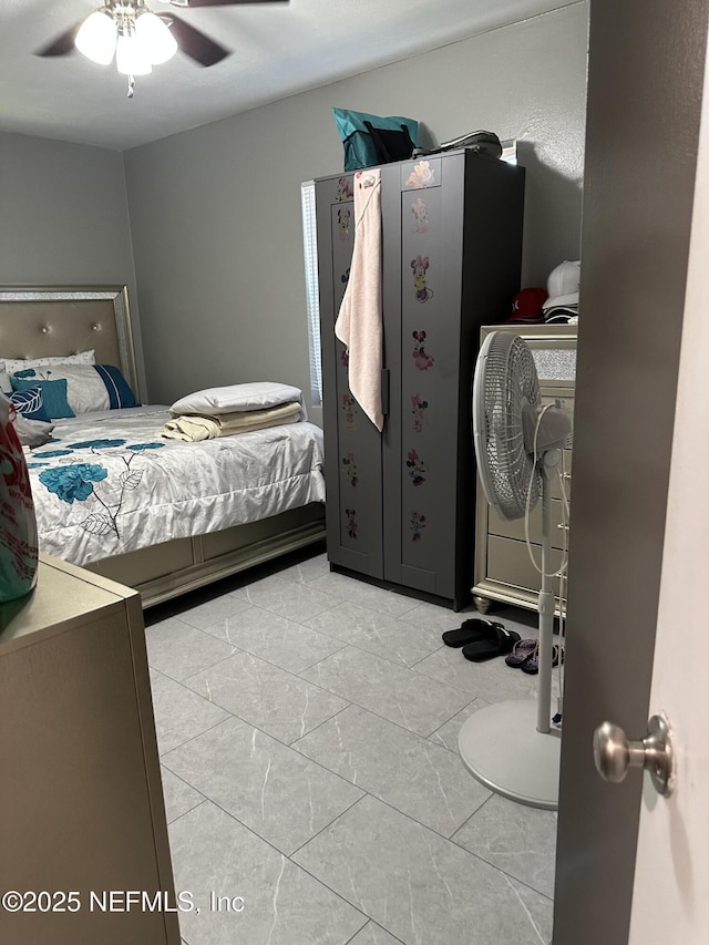 4040 Shasta Dr, Jacksonville, FL 32207 - bedroom with ceiling fan and marble look tile flooring
