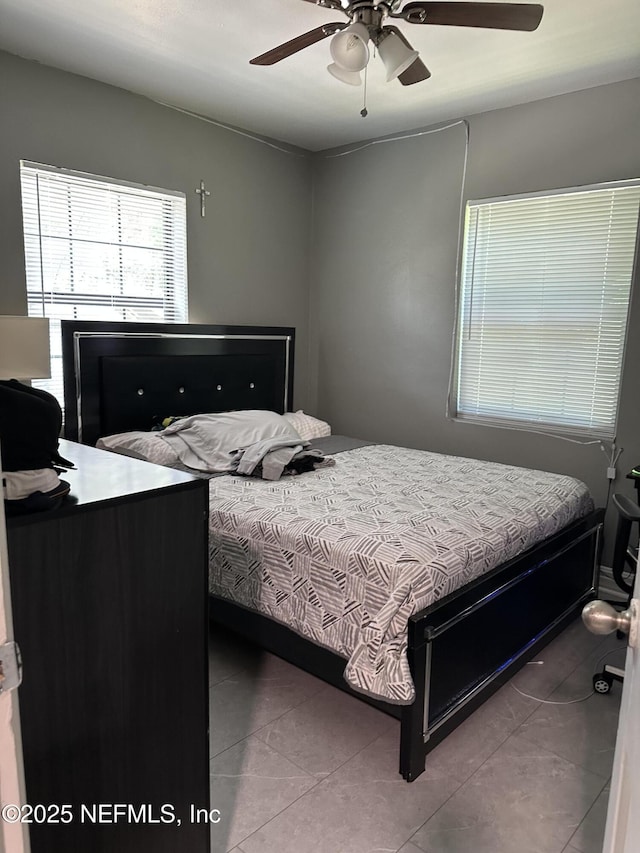 4040 Shasta Dr, Jacksonville, FL 32207 - tiled bedroom featuring a ceiling fan