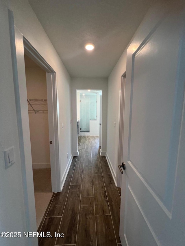 96100 Pirates Bluff Rd, Yulee, FL 32097 - hallway featuring dark wood-style flooring and baseboards