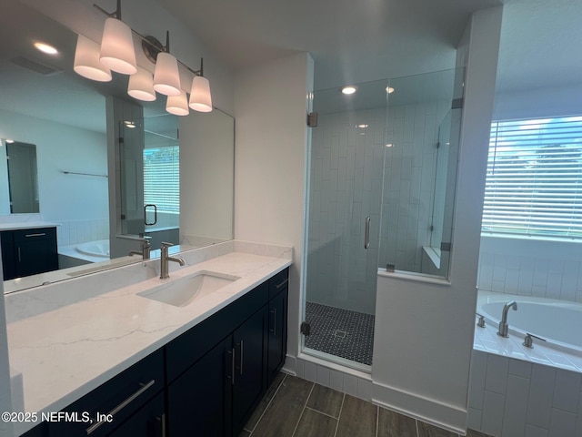 96100 Pirates Bluff Rd, Yulee, FL 32097 - bathroom with vanity, a shower stall, a bath, wood finished floors, and recessed lighting