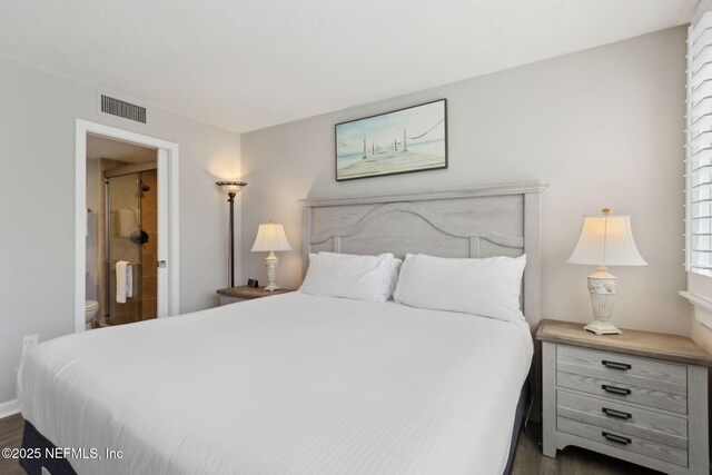 1165 Beach Walker Rd, Fernandina Beach, FL 32034 - bedroom with dark wood-style floors and ensuite bathroom