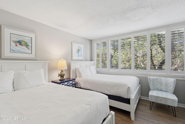 1165 Beach Walker Rd, Fernandina Beach, FL 32034 - bedroom with dark wood-style flooring, a textured ceiling, and baseboards