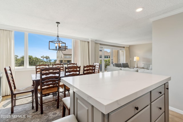 1165 Beach Walker Rd, Fernandina Beach, FL 32034 - kitchen featuring a textured ceiling, a chandelier, healthy amount of natural light, gray cabinetry, and recessed lighting