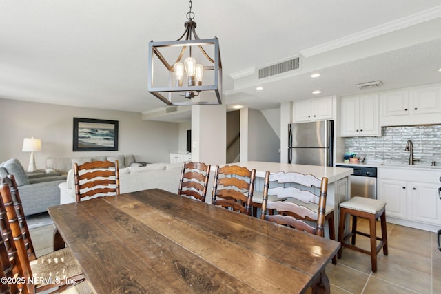 1165 Beach Walker Rd, Fernandina Beach, FL 32034 - dining area featuring light tile patterned floors, a chandelier, recessed lighting, and crown molding