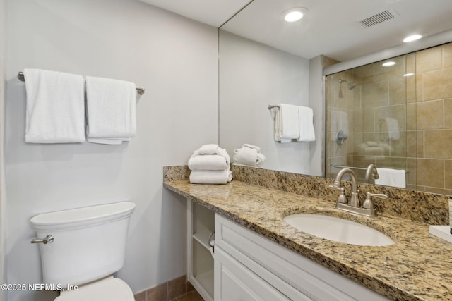 1165 Beach Walker Rd, Fernandina Beach, FL 32034 - bathroom featuring vanity, toilet, a tile shower, baseboards, and recessed lighting