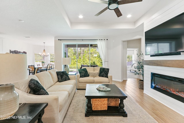 264 Windermere Way, Saint Augustine, FL 32095 - living area featuring a ceiling fan, wood finished floors, baseboards, recessed lighting, and a tray ceiling
