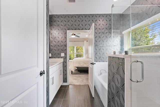 264 Windermere Way, Saint Augustine, FL 32095 - full bathroom featuring wallpapered walls, ensuite bath, a garden tub, a shower stall, and vanity