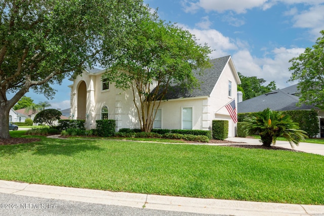 6547 Burnham Cir, Ponte Vedra Beach, FL 32082 - view of front of house featuring driveway, a garage, a front lawn, stucco siding, and roof with shingles