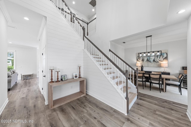6547 Burnham Cir, Ponte Vedra Beach, FL 32082 - staircase featuring ornamental molding, wood finished floors, recessed lighting, wooden walls, and a chandelier