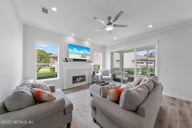 6547 Burnham Cir, Ponte Vedra Beach, FL 32082 - living room featuring ornamental molding, wood finished floors, a fireplace, healthy amount of natural light, and recessed lighting