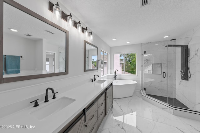 6547 Burnham Cir, Ponte Vedra Beach, FL 32082 - full bathroom featuring a textured ceiling, recessed lighting, a freestanding bath, a marble finish shower, and double vanity