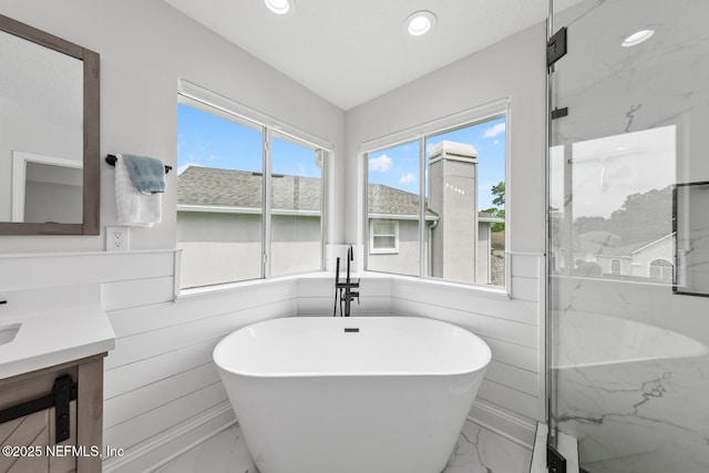 6547 Burnham Cir, Ponte Vedra Beach, FL 32082 - full bath with marble look tile flooring, vanity, a freestanding tub, recessed lighting, and a marble finish shower